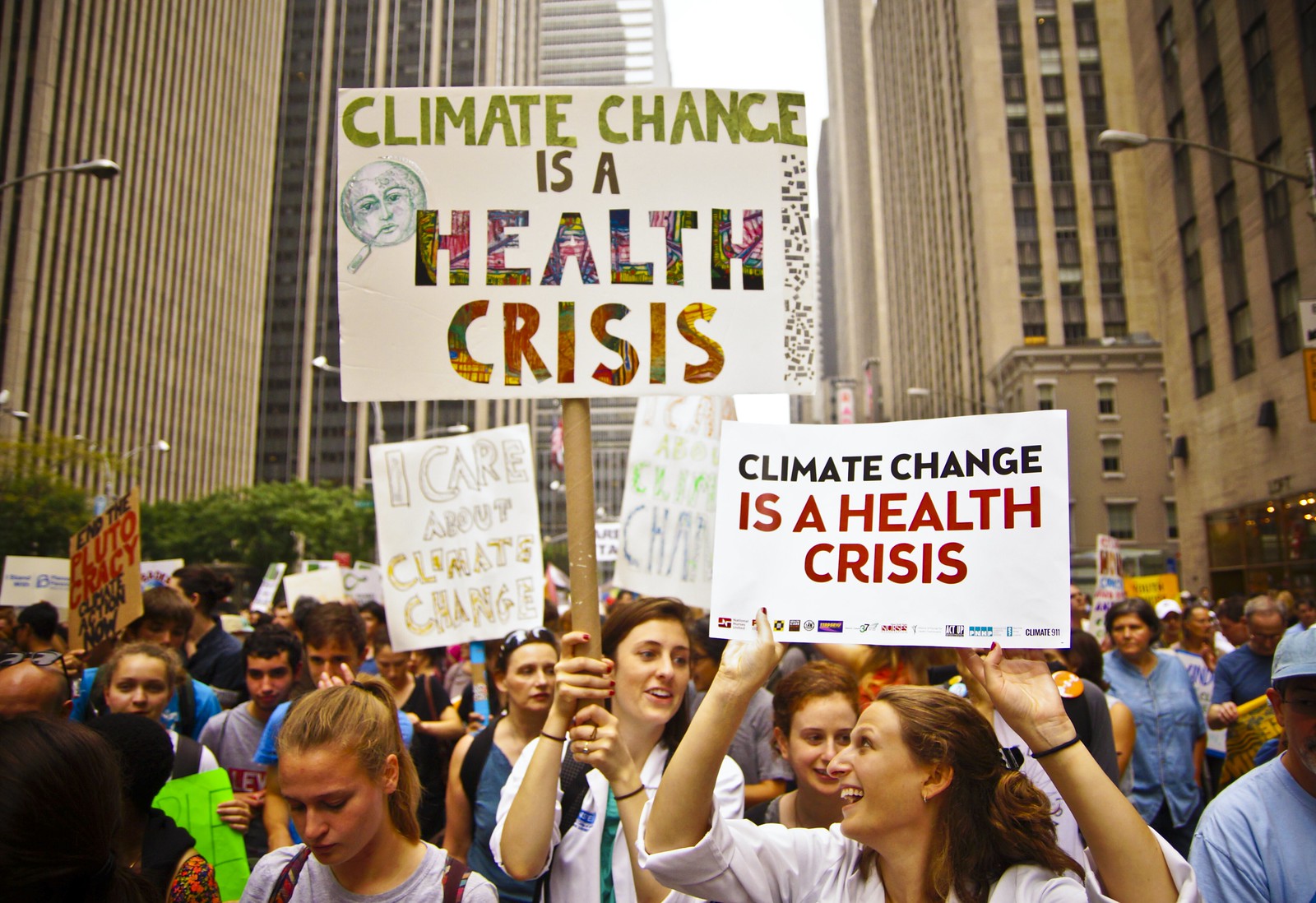 Marchers with Climate Change is a Health Crisis signs
